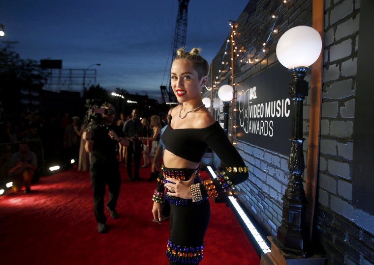 Image: Singer Miley Cyrus poses as she arrives for the 2013 MTV Video Music Awards in New York